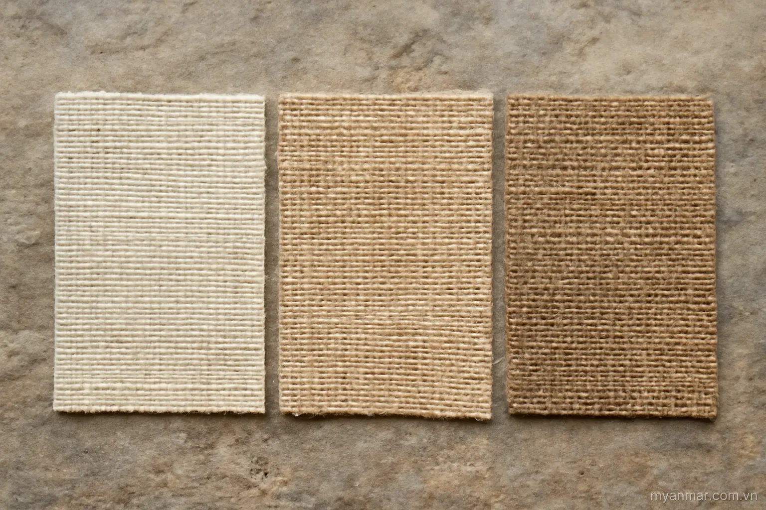 Three cloth samples of different weave densities laid side by side on stone, overhead, no text