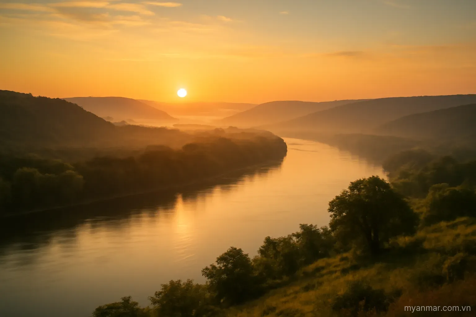 A wide river valley at sunrise with mist over distant hills, wide view, no text