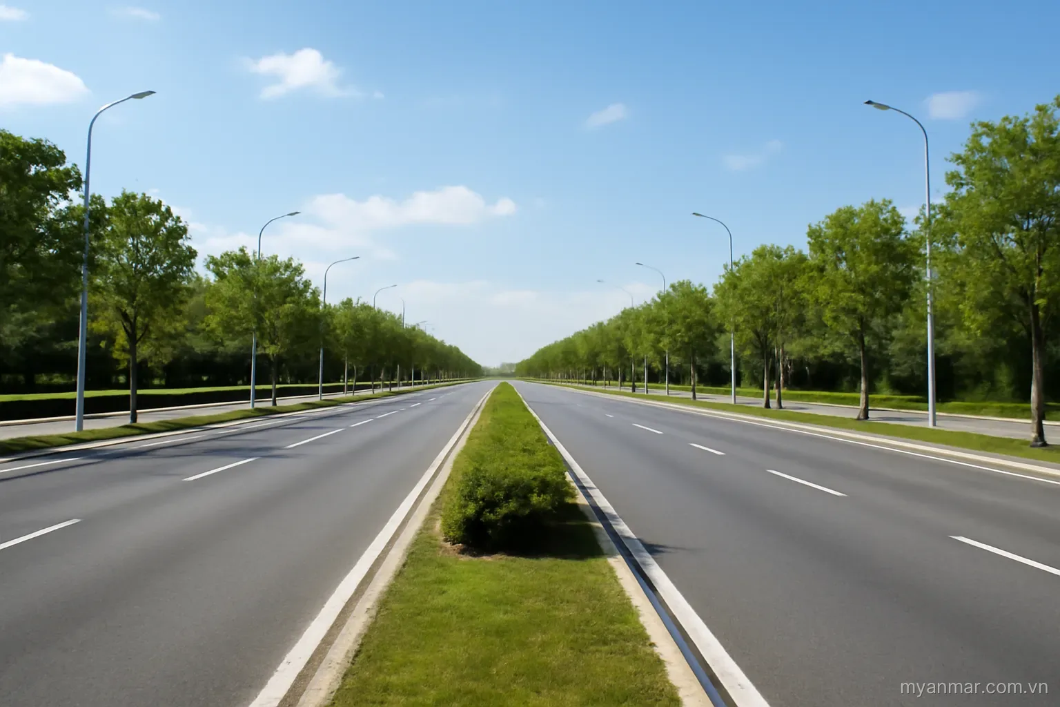 An extremely wide empty boulevard with landscaped median under bright sky, wide view, no text